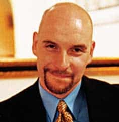A picture of a bearded man wearing a suit.