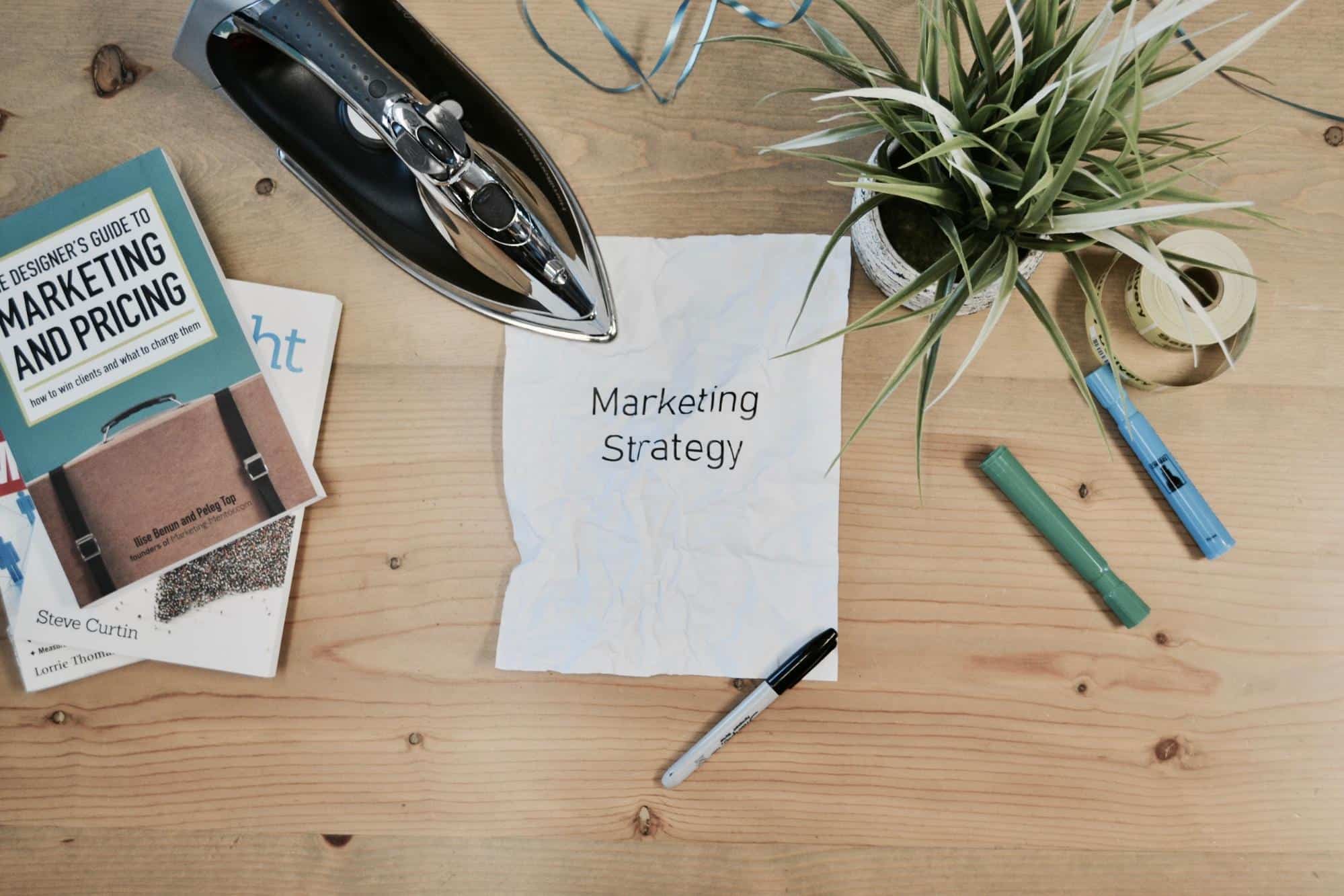 Marketing Strategy written in a paper beside an iron.