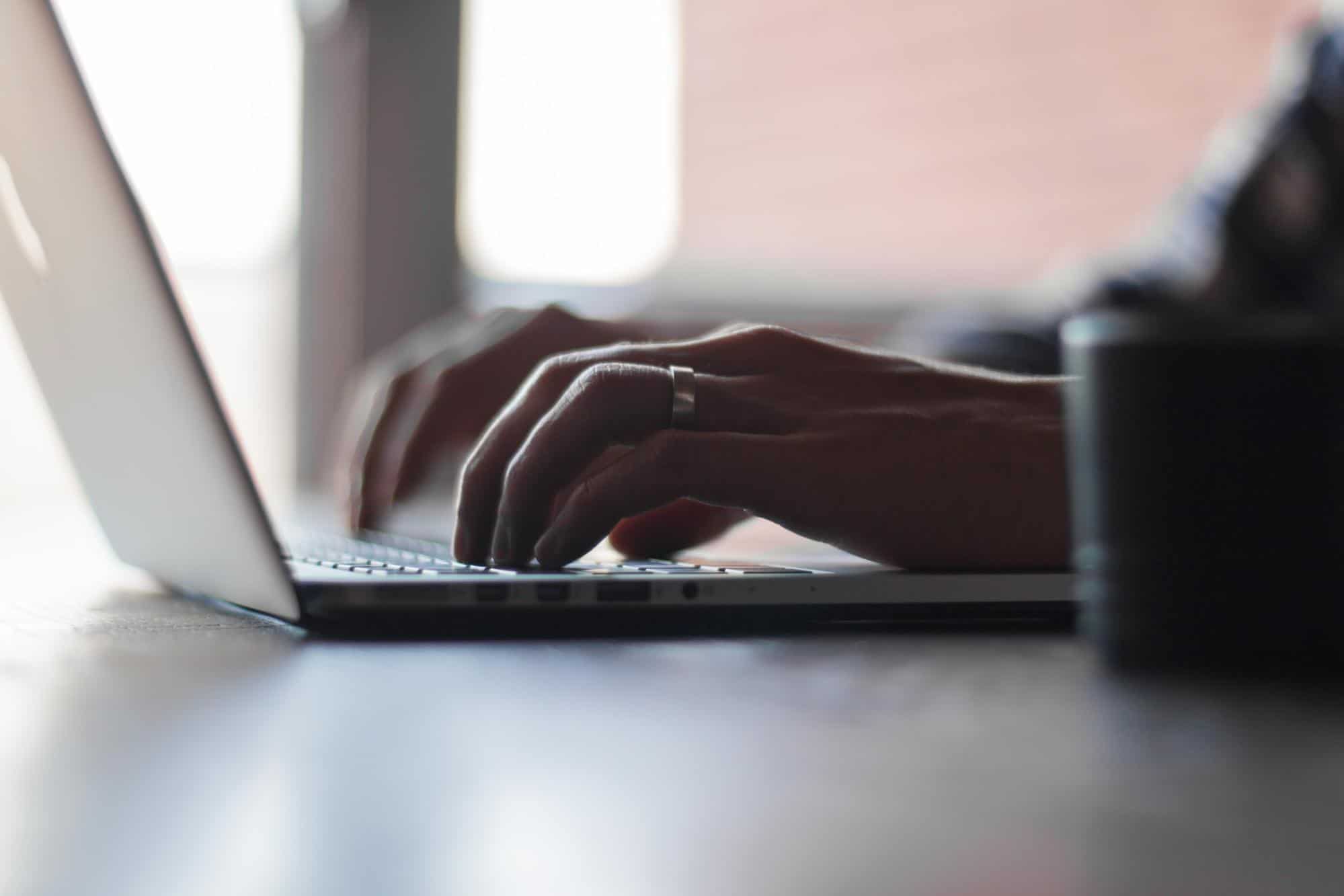 A person typing on the laptop