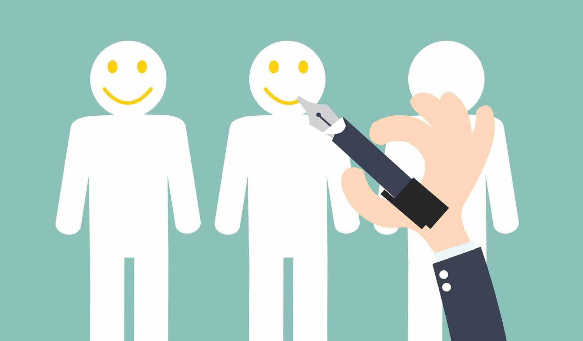 A person is holding a pen in front of a group of smiling people.