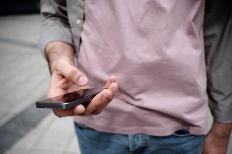 A man holding a smartphone in his hand.