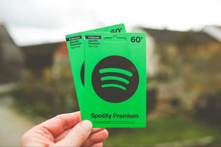 image2 A person is holding up a spotify premium card.