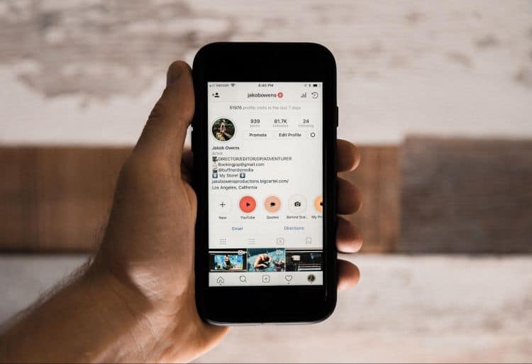 A person holding a phone with an instagram app on it.