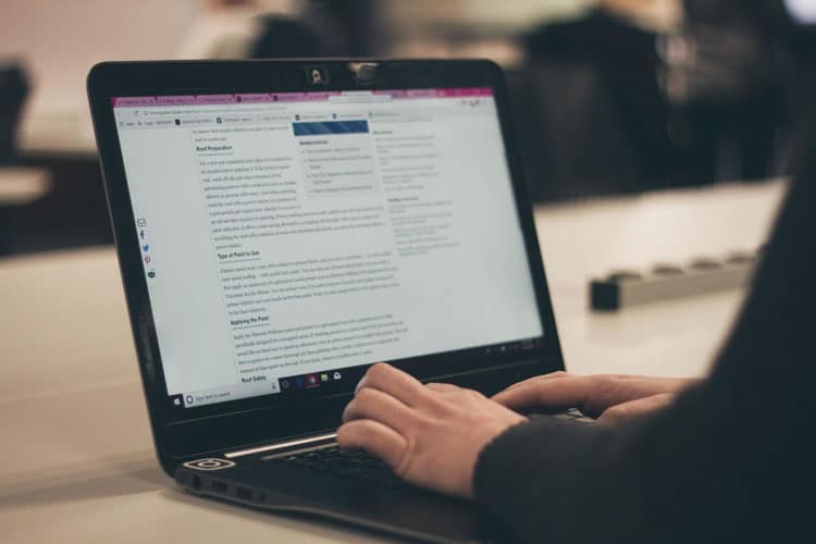 A person typing on a laptop computer.