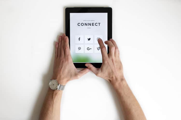A man holding a tablet with the word connect on it.