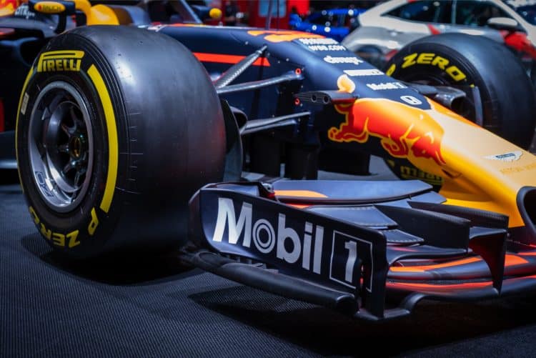 image3 A red bull racing car is on display at an auto show.
