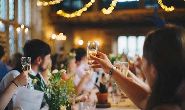 celebration A group of people toasting champagne at a wedding reception.
