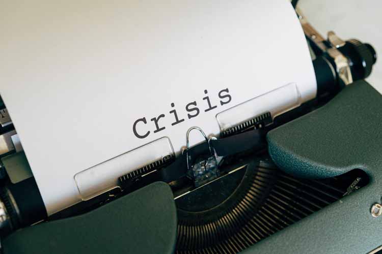 A typewriter with the word crisis written on it.