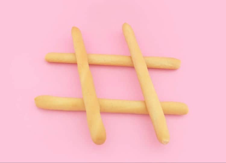 A set of hash tags on a pink background.