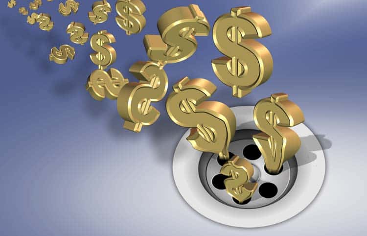 Gold dollar signs coming out of a drain.