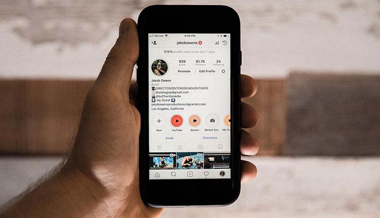 Instagram A person holding up a phone with an instagram app on it.