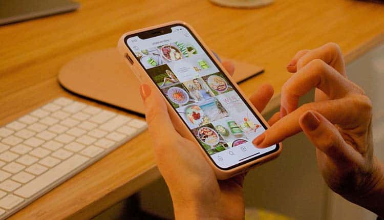 A woman's hand is holding a phone with a picture on it.