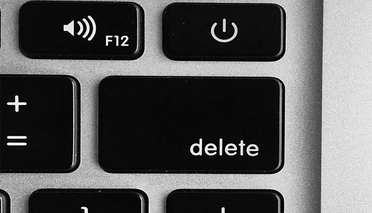 A black and white photo of a keyboard with the word delete.