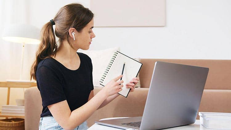 young lady explaining using her notebook and laptop