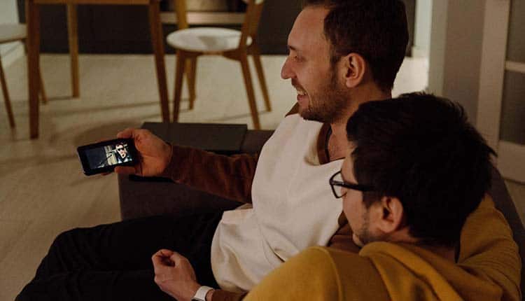 Two men watching Video