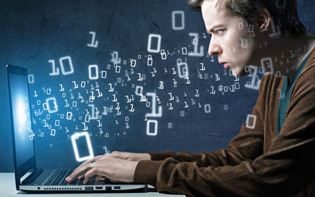 A man is working on a laptop with binary numbers coming out of his head.
