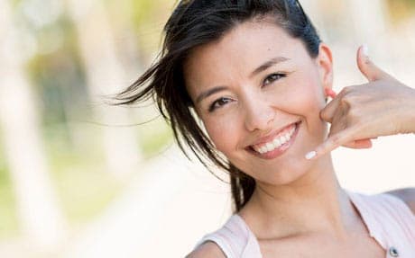 A woman is giving a thumbs up sign.