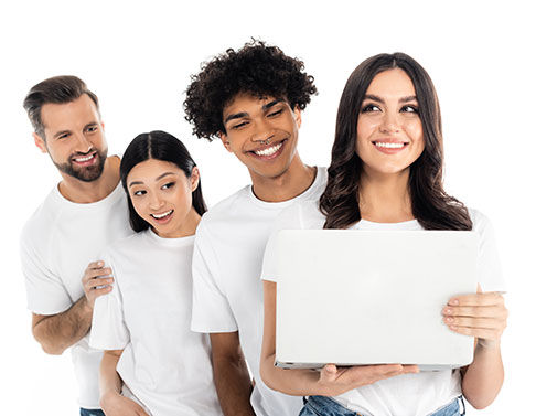 A group of people holding up a laptop.